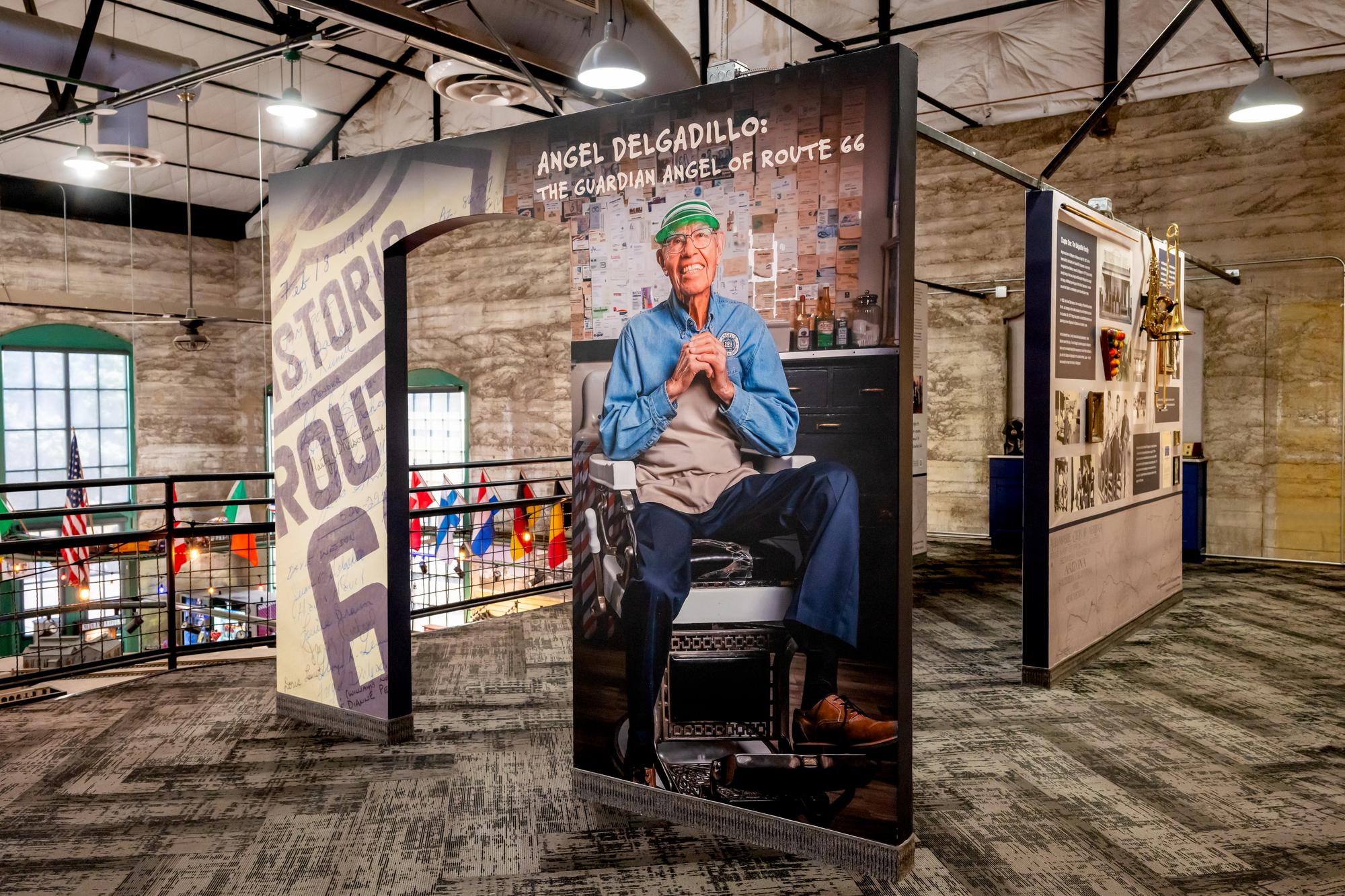 Angel Delgadillo: The Guardian Angel of Route 66 display inside the Kingman Visitor Center. A picture of Angel Delgadillo on his barber chair