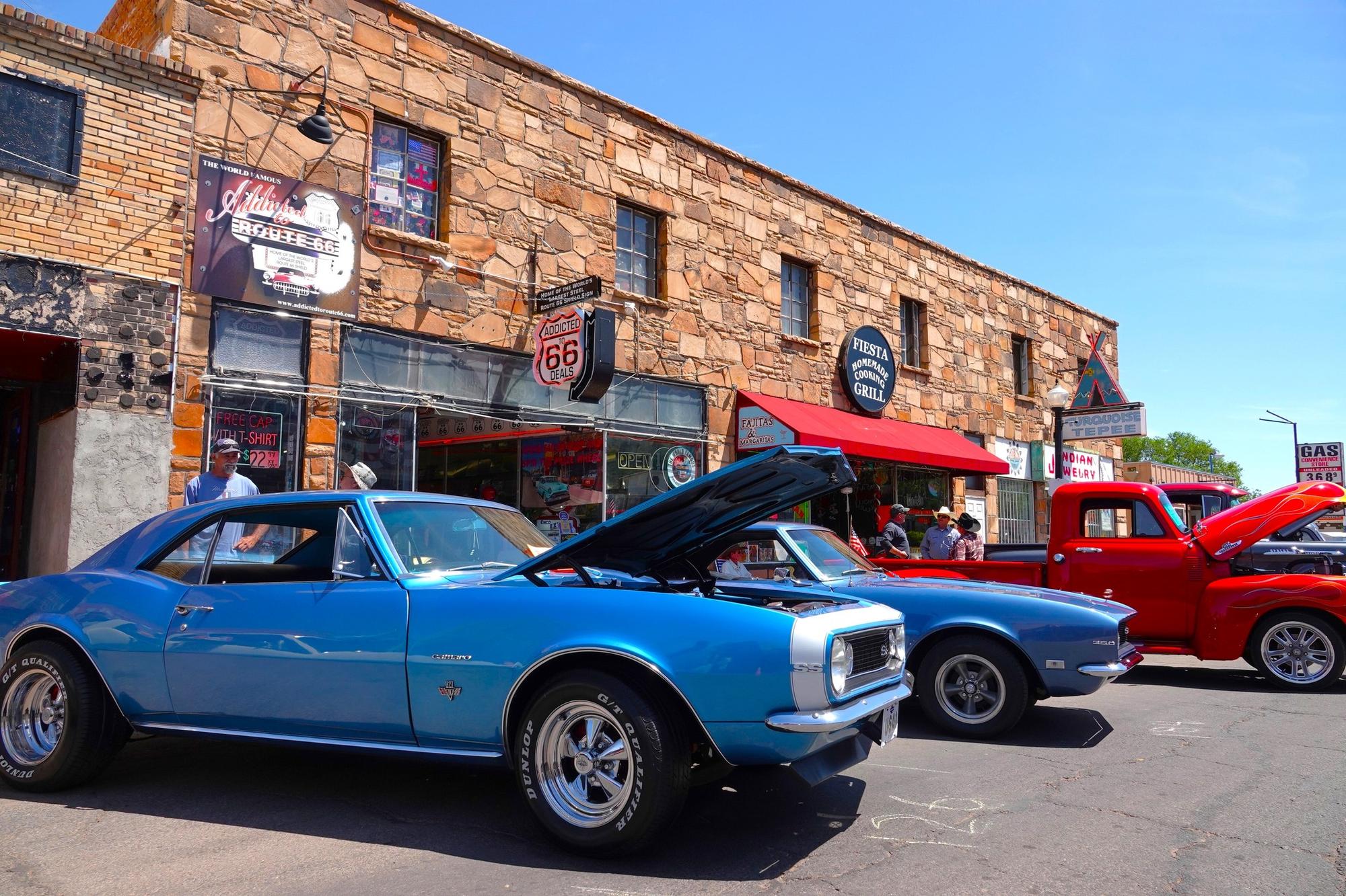 three classic cars lining the street of Williams Arizona