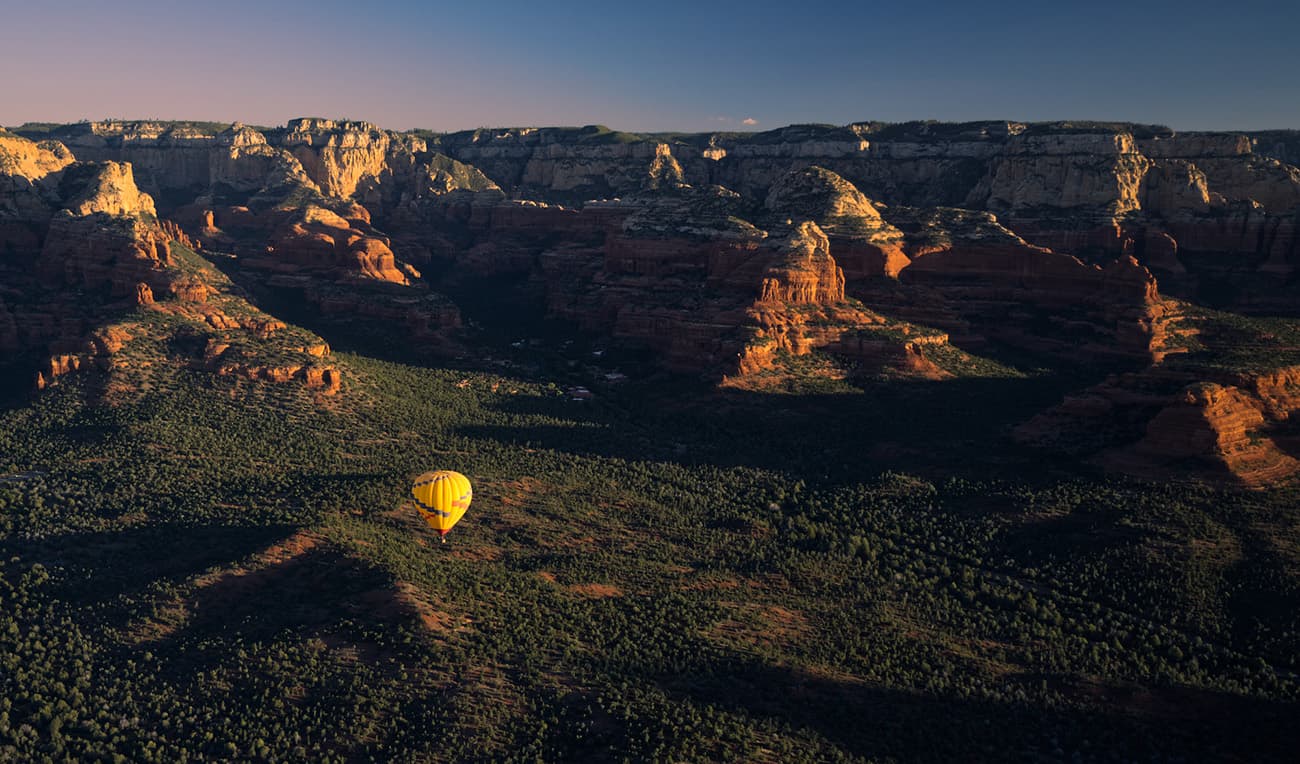 Yellow balloon hovering in front of Sedona red rocks